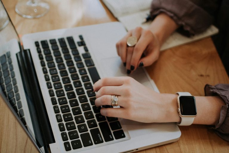 woman working on laptop improving her website SEO